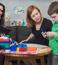 A counselor and parent interacting with a child during Children and Teen Counseling in Peoria IL