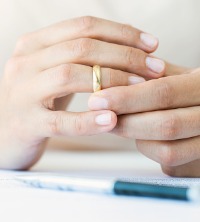 Spouse taking off ring after participating in Divorce and Family Mediation in Peoria IL