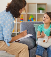 A counselor working with a child and discussing her ADHD and Learning Problems in Peoria IL