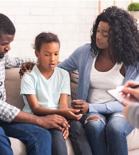 Parents sitting with child during Children and Teen Counseling in Peoria IL