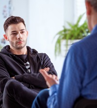 Man discussing anxieties with a counselor during Anxiety Therapy in Peoria IL