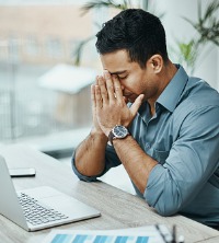 A man on his computer, dealing with Stress Management in Peoria IL