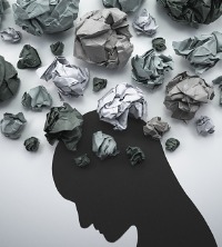 Crumpled up notes, looking like stormy clouds around someone's head, representing what Anxiety can sometimes feel like