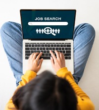 A woman on a laptop, job searching and looking for a Career Change in Peoria IL