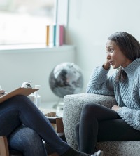 A woman sitting down with a counselor, talking about Anger and Conflict Management in Peoria IL 