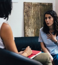 Woman talking with a counselor about issues with Codependency and Children of Alcoholics in Peoria IL