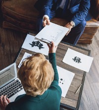 A person administering Psychological Testing to a client in Peoria IL