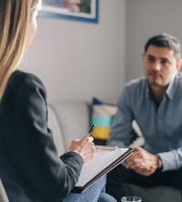 Substance Abuse and Addiction counselor talking with a patient